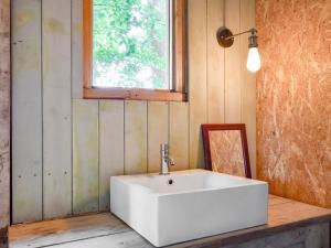 a bathroom with a white sink and a window at Coastal Views in Cloughton