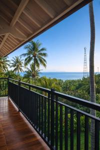 a balcony with a view of the ocean at Segara Hill Villa in Senggigi