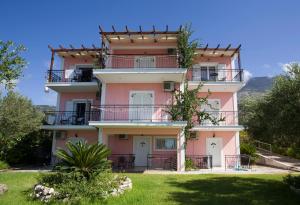a pink apartment building with aventh floor at Elpida Studio in Trapezaki