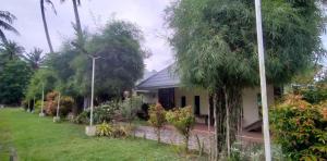 a house with a garden in front of it at Lantau Beach Resort in Tukuran