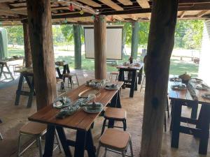 a long wooden table in a pavilion with chairs at Harris Cottage in Rathdowney