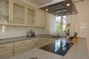 a kitchen with white cabinets and a counter top at SeWeR Apartment in Baden-Baden