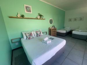 a bedroom with a large bed in a room at Forest Gate Apartments and Rooms in Plettenberg Bay