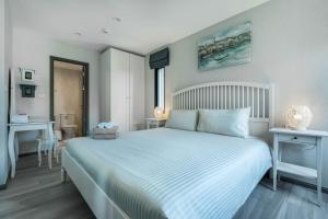 a bedroom with a large white bed and a desk at Studio Apartment by the Sea E413 in Phuket +29 photos
