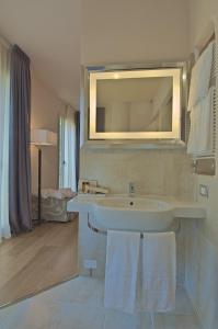 a bathroom with a sink and a mirror at Zen Hotel Versilia in Marina di Pietrasanta