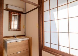 a bathroom with a sink and a mirror at sneaky peaks in Hakuba +60 photos