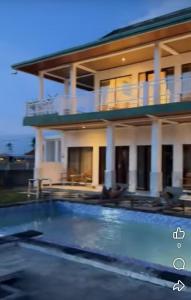 a house with a swimming pool in front of a house at Diana House in Amed in Amed