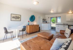 a living room with a couch and a table at Pohara's Beachside Gem in Pohara