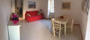sala de estar con sofá rojo y mesa en Appartamento Le Tre Volte, en Matera
