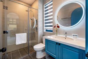 a bathroom with a toilet and a sink and a mirror at Suri Villa in Bình Tú +136 photos