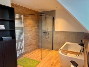 a bathroom with a shower and a bath tub at Beehome Wietzendorf in Wietzendorf