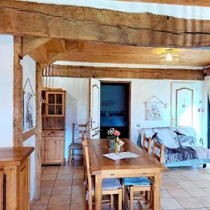 a bedroom with a wooden table and a bed at Gîte Laguës in Poueyferré