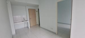 a white kitchen with a sink and a mirror at Apartement ayodhya 2BR Unfurnished in Tjikokol