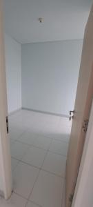 an empty room with a white floor and white walls at Apartement ayodhya 2BR Unfurnished in Tjikokol