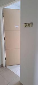 a door in a room with a sign on it at Apartement ayodhya 2BR Unfurnished in Tjikokol