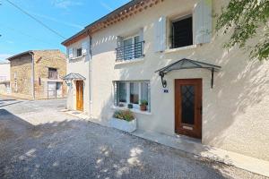 a white building with a door on the side of it at Gîte paumajoly in Castres