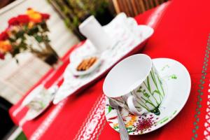 a red table with white plates and spoons on it at Gîte paumajoly in Castres