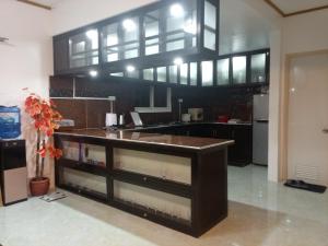 a kitchen with a large island in the middle at Lancaster new city in General Trias