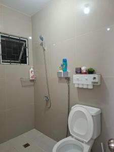 a bathroom with a white toilet and a shower at Lancaster new city in General Trias +20 photos