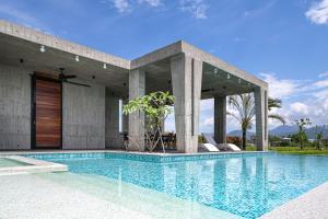a house with a swimming pool in front of it at 135 會館 135 Private Villa Yilan in Dongshan