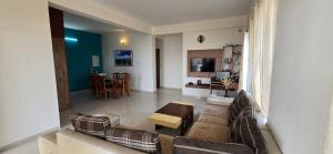 a living room with a couch and chairs and a table at Konark Villa in Mahabaleshwar