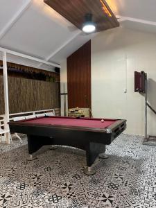 a pool table sitting on top of a floor at SeventhHeaven Nasugbu in Reparo