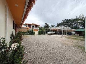 a gravel driveway next to a house with a car parked at SeventhHeaven Nasugbu in Reparo