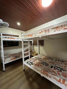 a bedroom with two bunk beds and a wooden ceiling at SeventhHeaven Nasugbu in Reparo