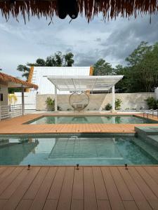 a swimming pool with a canopy over a wooden deck at SeventhHeaven Nasugbu in Reparo +20 photos