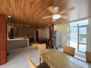 a dining room with a ceiling fan and a table at SeventhHeaven Nasugbu in Reparo