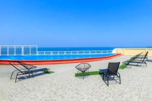 a group of chairs and tables on a beach at Collection O Hotel Paris FC, Veracruz in Veracruz