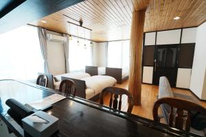 a living room with a table and some chairs at SAMURISE No.4 in Fujikawaguchiko