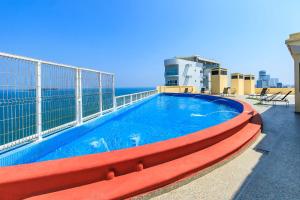 a swimming pool on the roof of a building at Collection O Hotel Paris FC, Veracruz in Veracruz