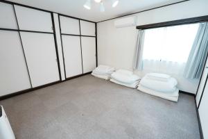 a room with two beds and a large window at SAMURISE No.4 in Fujikawaguchiko