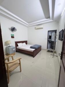 a bedroom with a bed and a chair in it at Ninh Binh Friendly Hotel in Ninh Binh