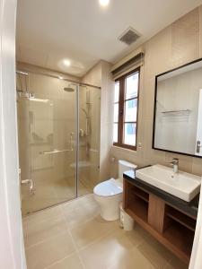 a bathroom with a shower and a toilet and a sink at Leto Hotel Central Sunset Town in Phú Quốc +54 photos