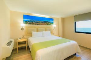 a hotel room with a bed and a large window at Collection O Hotel Paris FC, Veracruz in Veracruz