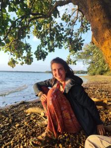 a woman sitting on the beach under a tree at Arasu Homestay in Antarasante +15 photos