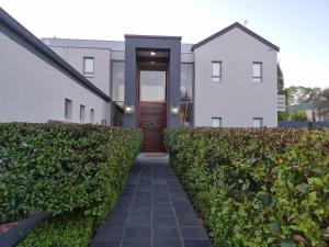a home with a walkway leading to the front door at Riverfront Golf Estate House in Parys