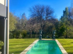 a swimming pool in the yard of a house at Riverfront Golf Estate House in Parys