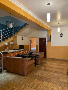 a large living room with couches and a staircase at Hotel The Mint Garden in Pokhara