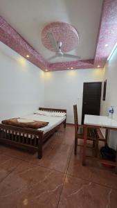 a room with a bed and a ceiling fan at MIST RESIDENCY in Kattappana