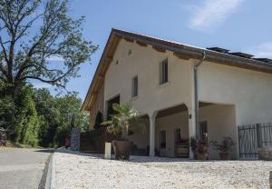 a large white house with a tree in front of it at LE NID DES PLANCHETTES - Suite Chambres d'Hôtes in Germéfontaine