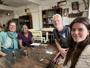 a group of people sitting at a table at Arasu Homestay in Antarasante