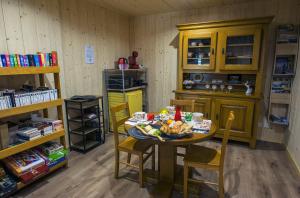 a kitchen with a table with food on it at LE NID DES PLANCHETTES - Suite Chambres d'Hôtes in Germéfontaine