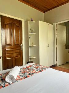 a bedroom with a bed and a wooden door at Westbreeze Residences in Nairobi