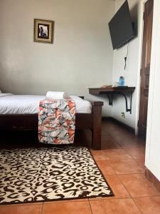 a room with a bed and a table and a rug at Westbreeze Residences in Nairobi