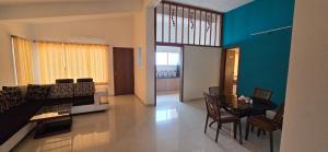 a living room with a couch and a table at Konark Villa in Mahabaleshwar