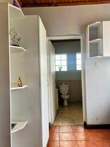 an empty bathroom with a toilet in a room at Westbreeze Residences in Nairobi