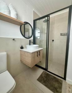 a bathroom with a sink and a shower at Fisherman's Rest in Paternoster +24 photos